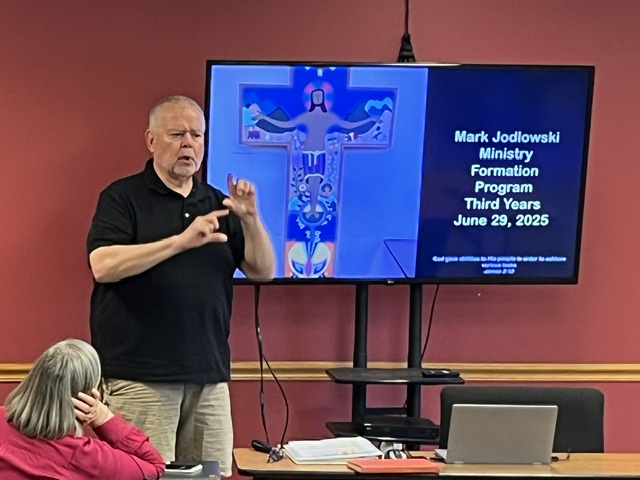 Instructor presenting in American Sign Language during an MFP religious education workshop